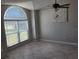 A living room featuring ceramic tile, a ceiling fan, a big window, and light-grey walls at 2798 Beckwith St, Deltona, FL 32738