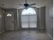 A living room featuring ceramic tile, a ceiling fan, and a big window at 2798 Beckwith St, Deltona, FL 32738