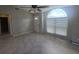 A living room featuring ceramic tile, a ceiling fan, a big window, and light-grey walls at 2798 Beckwith St, Deltona, FL 32738