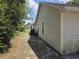 Home's side yard exterior features traditional siding and standard windows at 2798 Beckwith St, Deltona, FL 32738