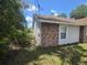 Home's side exterior features a brick facade and a standard window at 2798 Beckwith St, Deltona, FL 32738