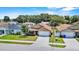 Aerial view of a home in a residential neighborhood with mature trees and well-maintained lawns at 2980 Cool Breeze Cir, St Cloud, FL 34769