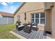 Inviting back patio features outdoor seating and a view of the home's landscaped backyard at 2980 Cool Breeze Cir, St Cloud, FL 34769