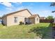 A spacious yard, with a patio and dark-wicker furniture, great for entertaining guests in the backyard at 2980 Cool Breeze Cir, St Cloud, FL 34769