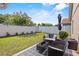 Private backyard features a patio with outdoor furniture and lush green lawn at 2980 Cool Breeze Cir, St Cloud, FL 34769