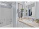 Bright bathroom with a single sink vanity and a shower-tub combination at 2980 Cool Breeze Cir, St Cloud, FL 34769