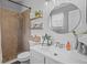 Bright bathroom features a shower, shiplap accent wall, updated vanity, and modern fixtures at 2980 Cool Breeze Cir, St Cloud, FL 34769