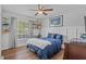 Comfortable bedroom with wood floors, a ceiling fan, and stylish decor at 2980 Cool Breeze Cir, St Cloud, FL 34769