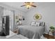 Charming bedroom with a ceiling fan, grey walls, wood-look floors, and comfortable furnishings at 2980 Cool Breeze Cir, St Cloud, FL 34769