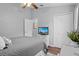 Well-lit bedroom with a TV, closet, and soothing wall decor for a relaxing ambiance at 2980 Cool Breeze Cir, St Cloud, FL 34769
