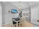 Open dining room features an elegant light fixture, neutral paint and seating for four at 2980 Cool Breeze Cir, St Cloud, FL 34769