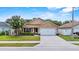 Lovely single-story house with a tidy front yard and an attached two-car garage at 2980 Cool Breeze Cir, St Cloud, FL 34769
