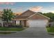 Charming single-story home featuring a well-manicured lawn and a two-car garage at 2980 Cool Breeze Cir, St Cloud, FL 34769