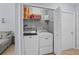 Convenient laundry room with washer, dryer, shelving, and ample storage space at 2980 Cool Breeze Cir, St Cloud, FL 34769