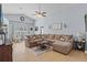 Cozy living room featuring a plush sectional sofa, ceiling fan, and vaulted ceiling at 2980 Cool Breeze Cir, St Cloud, FL 34769