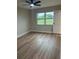 A bright bedroom with modern flooring, fan, and view of the outdoors at 3 Spur Ct, Kissimmee, FL 34743