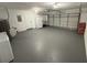 Spacious garage with ample storage and a clean, painted floor provides plenty of room for vehicles and projects at 3 Spur Ct, Kissimmee, FL 34743