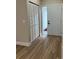 Clean hallway featuring modern flooring, closet and a unique atrium providing natural light at 3 Spur Ct, Kissimmee, FL 34743