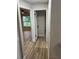 Hallway leading to a bedroom with ceiling fan and natural light, offering ample space at 3 Spur Ct, Kissimmee, FL 34743