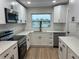 Contemporary kitchen featuring white cabinetry, subway tile backsplash, and stainless steel appliances at 3 Spur Ct, Kissimmee, FL 34743