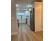Modern kitchen featuring stainless steel appliances, white cabinetry, and wood flooring at 3 Spur Ct, Kissimmee, FL 34743