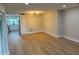 Spacious living room with new floors that opens to the kitchen with white cabinets at 3 Spur Ct, Kissimmee, FL 34743