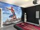 Finished basement featuring a Spiderman mural and a pool table for entertainment at 3012 Mahalo Dr, Davenport, FL 33897