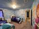 Disney themed bedroom with light blue walls, themed mural and furnishings at 3012 Mahalo Dr, Davenport, FL 33897
