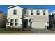 Two-story home with stone accents, a two-car garage, and well-maintained landscaping at 3012 Mahalo Dr, Davenport, FL 33897