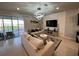 Well-lit living room with contemporary lighting fixtures, plush seating, and access to outdoor pool at 3012 Mahalo Dr, Davenport, FL 33897