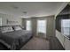 Bedroom with large windows, carpet flooring, and a TV on the wall at 3012 Mahalo Dr, Davenport, FL 33897