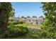The property's backyard features a lush lawn, mature trees, and white exterior at 306 Modest St, Lakeland, FL 33805