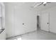 Bright bedroom featuring a ceiling fan, sleek tile floors, and white doors at 306 Modest St, Lakeland, FL 33805