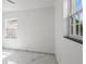 Bedroom with marble look tile flooring and windows at 306 Modest St, Lakeland, FL 33805