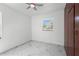 Bedroom with ceiling fan, window views, and marble-look tile floors at 306 Modest St, Lakeland, FL 33805