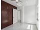 Bedroom with closet, modern ceiling fan, marble-look floors, and lots of natural light at 306 Modest St, Lakeland, FL 33805