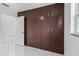 Bedroom featuring a closet, marble-look tile flooring, and natural light from the window at 306 Modest St, Lakeland, FL 33805