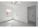 Bedroom featuring a ceiling fan, sleek tile floors, and multiple doors at 306 Modest St, Lakeland, FL 33805