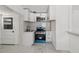 Well-lit kitchen featuring white cabinets, new stainless steel appliances, and elegant tile flooring at 306 Modest St, Lakeland, FL 33805