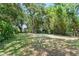 The lush green backyard with mature trees at 3115 Avenue U Nw, Winter Haven, FL 33881