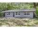 Charming one-story home with neutral gray paint, trimmed windows, and mature shade trees at 3115 Avenue U Nw, Winter Haven, FL 33881