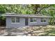 Cozy gray one-story home featuring trimmed windows and a concrete driveway at 3115 Avenue U Nw, Winter Haven, FL 33881