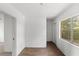 Hallway with fresh paint, wood-look floors, and views of the window and doorway at 3115 Avenue U Nw, Winter Haven, FL 33881