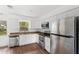 Modern kitchen features stainless steel appliances, granite countertops and bright lighting at 3115 Avenue U Nw, Winter Haven, FL 33881