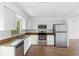 Modern kitchen features stainless steel appliances, granite countertops, and new appliances at 3115 Avenue U Nw, Winter Haven, FL 33881