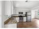 Modern kitchen features stainless steel appliances, granite countertops and ample lighting at 3115 Avenue U Nw, Winter Haven, FL 33881