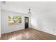 Bright living room features wood-look flooring, fresh white paint and lots of light from the window at 3115 Avenue U Nw, Winter Haven, FL 33881