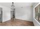 Bright living room leads to the kitchen with wood-look flooring and fresh white paint at 3115 Avenue U Nw, Winter Haven, FL 33881