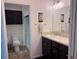 Well-lit bathroom featuring a single vanity, toilet, and a walk-in shower at 3328 Davis Ter, The Villages, FL 32163