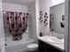 Bathroom features a tub-shower combo, neutral-tone walls, and decorative accents at 3328 Davis Ter, The Villages, FL 32163